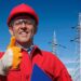 Portrait of Smiling Engineer in Red Hardhat and Coveralls